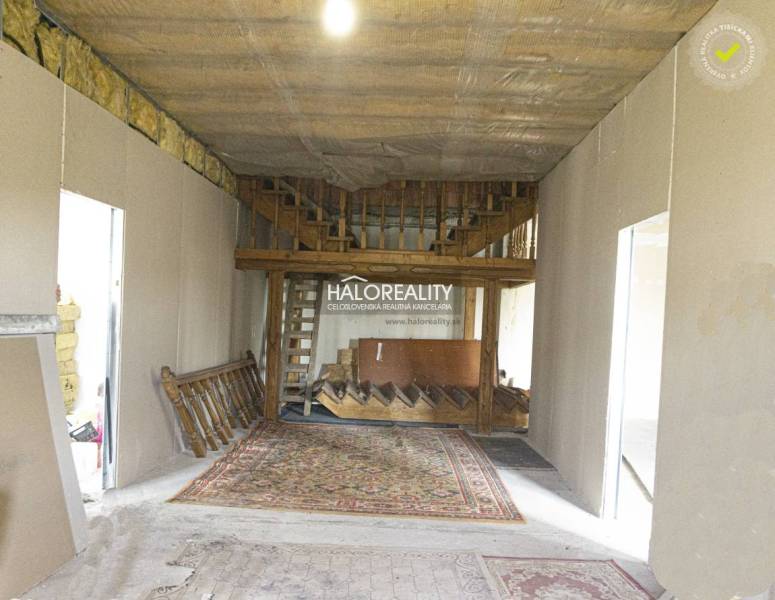 Interior of commercial premises with a wooden staircase and carpet.