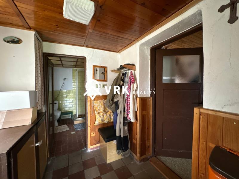Interior of a family house with entrance to the bathroom and coat hooks.