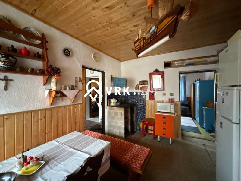 Interior of a family house with a wooden ceiling and rustic furnishings.