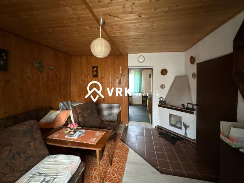 Living room in a family house with wooden wall and ceiling decor.