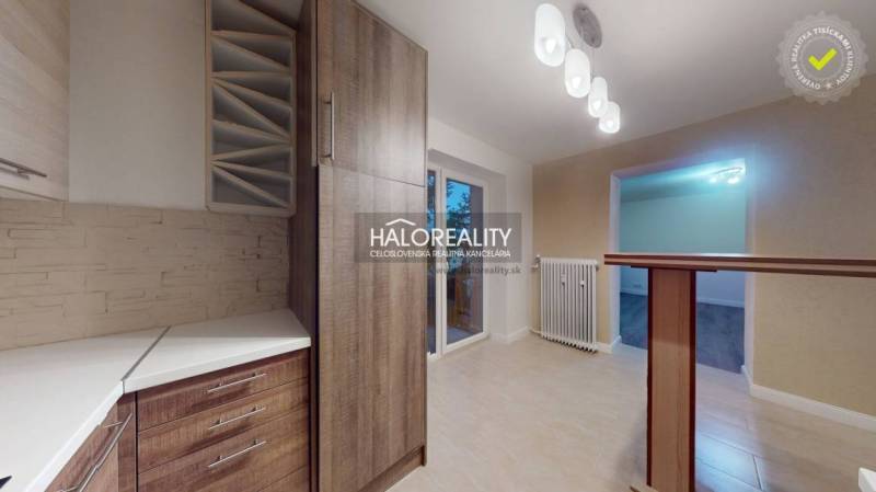 A kitchen in a 2-room apartment with a wooden decor floor and modern lighting.
