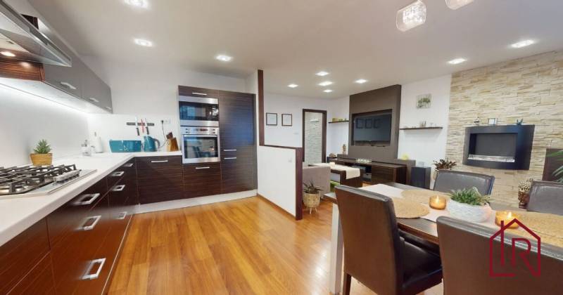 Kitchen and dining room in a 3-room apartment with a wooden decor floor.