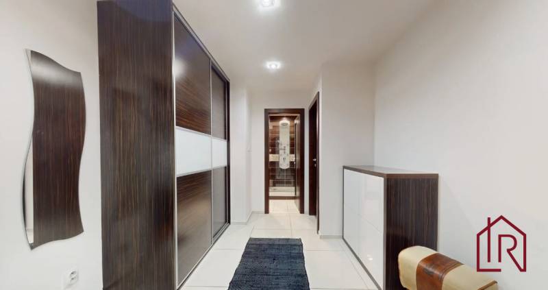 Hallway in a 3-room apartment with a built-in wardrobe and tiles.