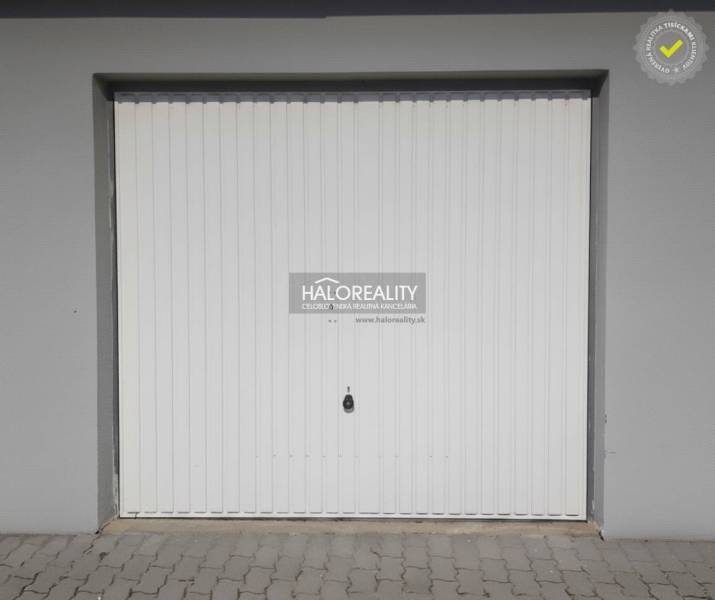 White garage door with paving in Borčice.