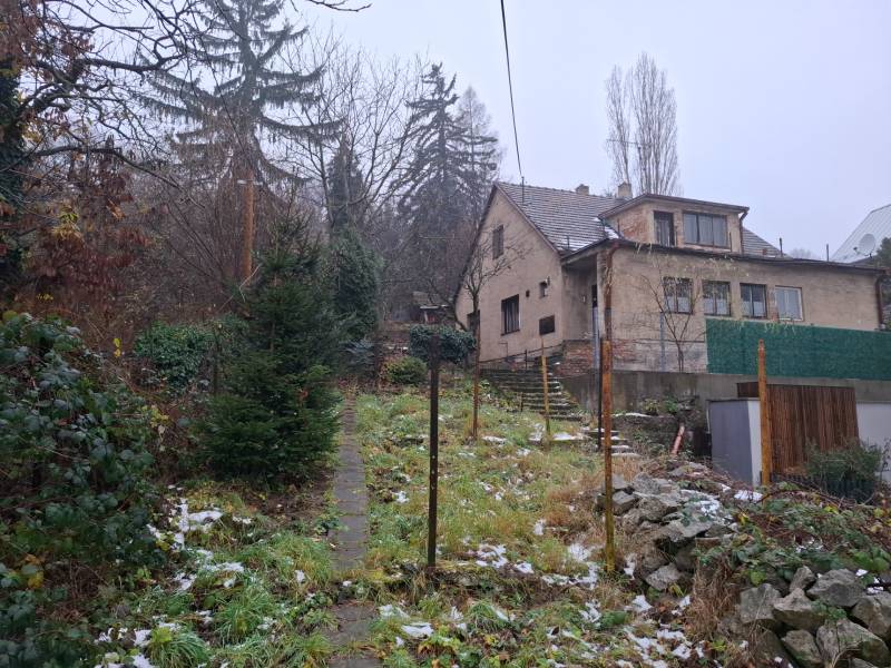 A family house on Búdková Street in Bratislava - Staré Mesto, surrounded by a snowy garden.
