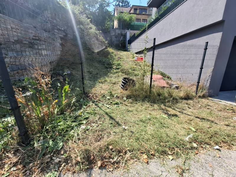 Enclosed slope in a Family House on Búdková in Bratislava - Old Town with vegetation.