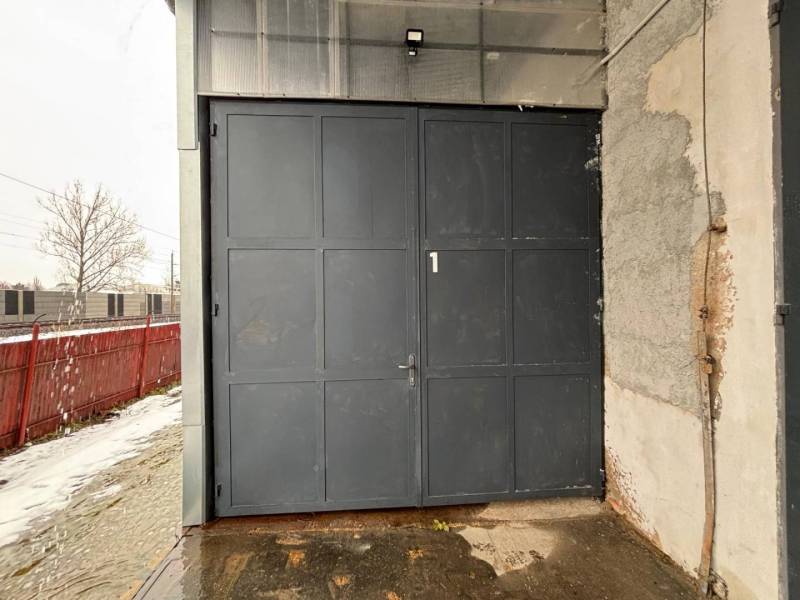Industrial entrance gate and walls in the offices of Poprad, snowy exteriors.