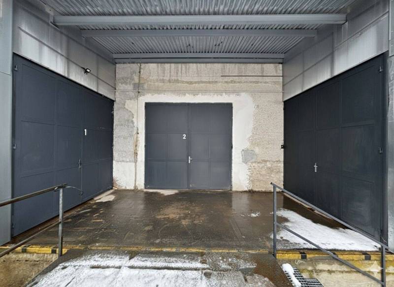 Three garage doors with metal fencing at the Offices in Poprad.