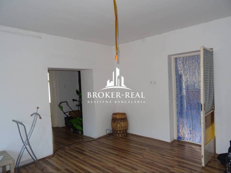 Living space in a family house with a wooden decor floor and white walls.