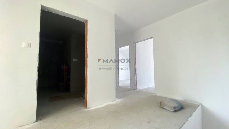 Interior construction in a family house with white walls and an unfinished floor.