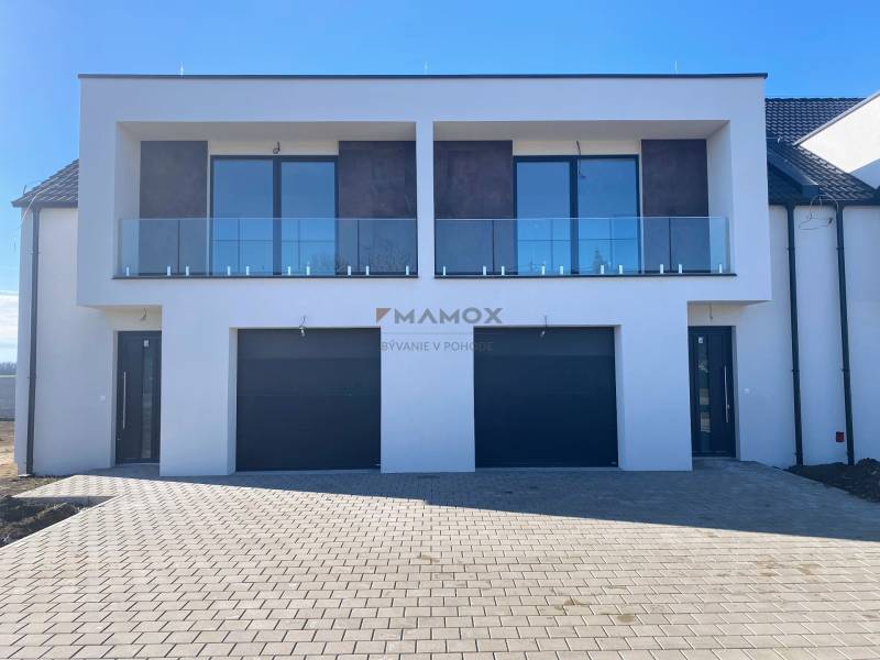 A family house on Polnokesovska Street in Mojmírovce with a glass balcony and a double garage.