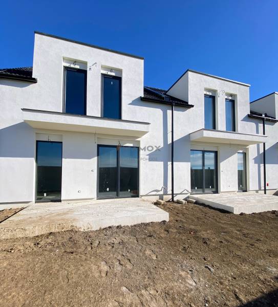 A family house on Polnokesovska Street in Mojmírovce with large windows and an undeveloped yard.