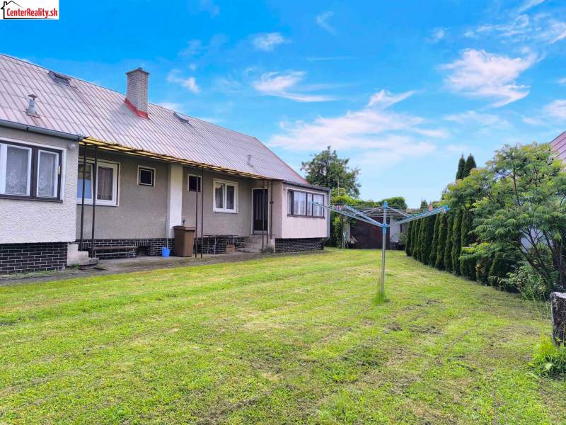 A family house in Nováky with a garden, lawn, and clothesline.