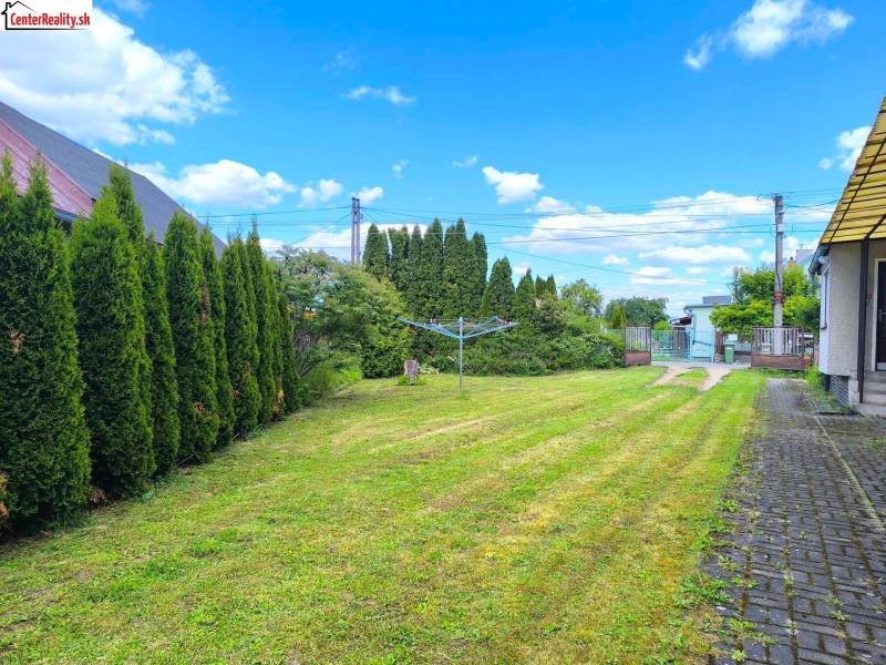 Garden area of a family house in Prievidza with a carefully maintained lawn and hedge.