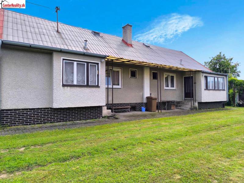 A family house in Nováky with a large grassy area and simple architecture.
