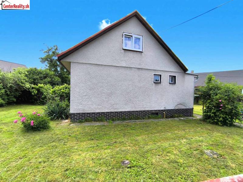 A family house in Nováky with a garden, lawn, and flowers in a pleasant environment.