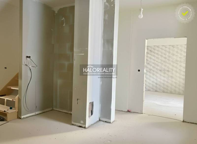 An unfinished renovation of a family house with exposed walls and an opening for a staircase.