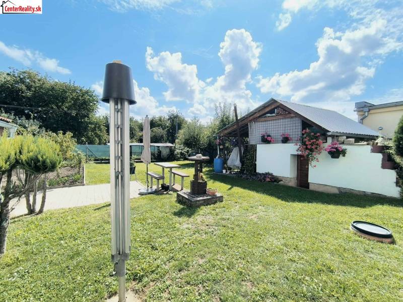 A garden in Partizánske with a gazebo and floral decorations by the family house.