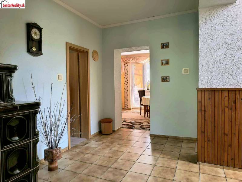 Interior of a family house with ceramic tiles, decorative cladding, and a ceramic stove.