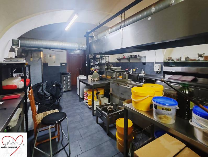 Kitchen spaces with equipment and utensils ready for use in a catering area.