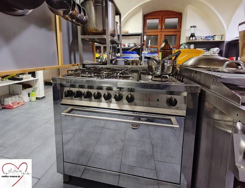 A kitchen with a gas stove and equipment in catering premises.