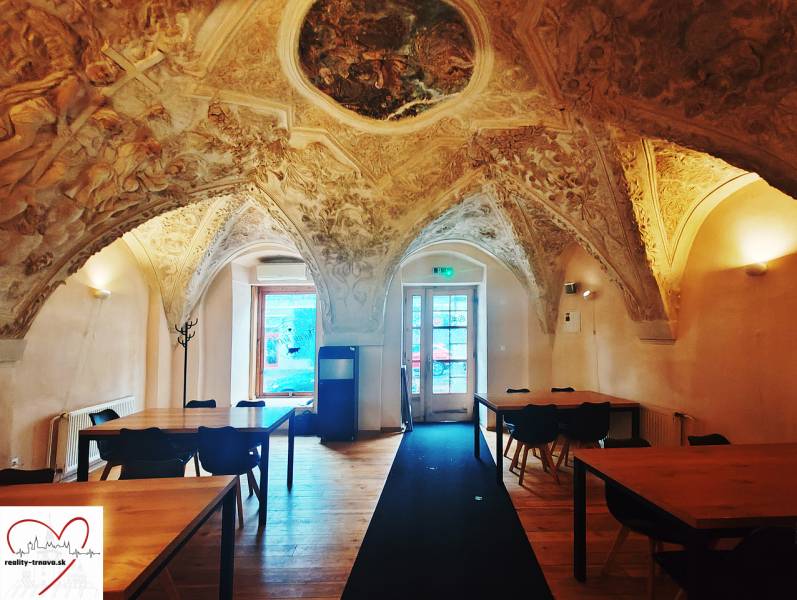 Interior of historic gastro spaces with a vaulted ceiling and a wooden decor floor.