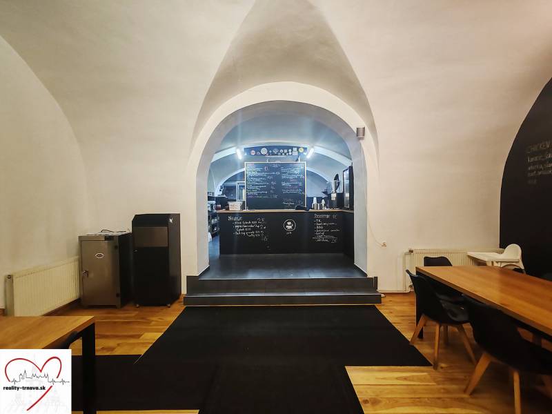 Interior of gastro spaces with vaults, chalkboard walls, and flooring with wood decor.