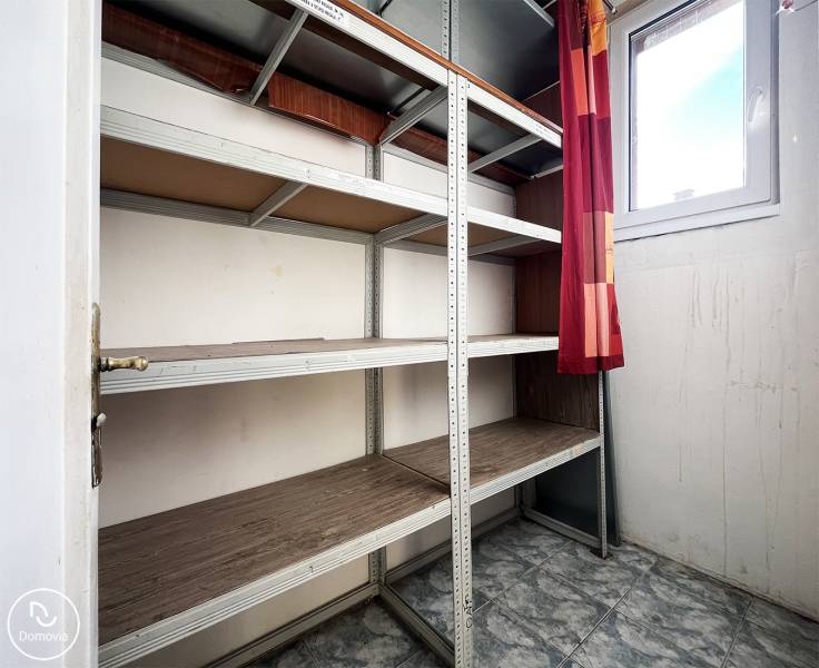 Storage space with shelves and tiled floor in a 5 or more room apartment.