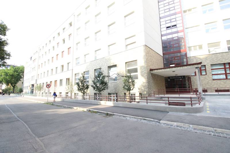 The building on Bezručova Street in Bratislava - Old Town with a ramp and trees.