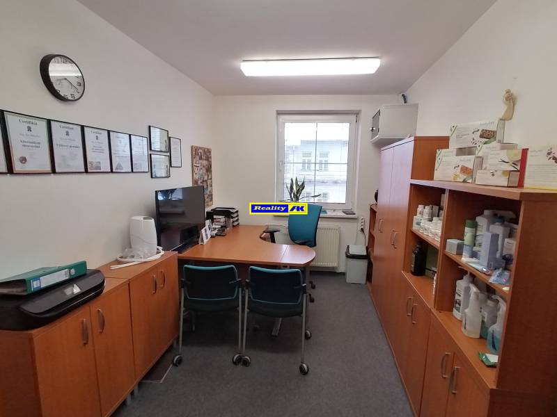 Offices with furniture, certificates on the wall, and shelves with products.