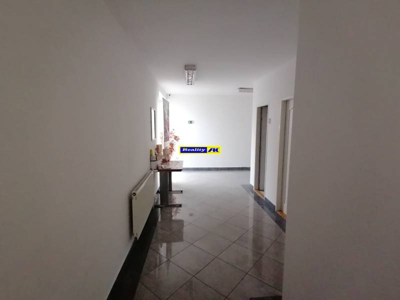 A corridor of offices with tiles and decoration.