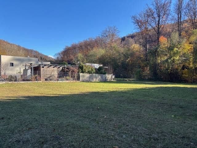 A grassy plot on Karpatská Street in Marianka, surrounded by forests, suitable for living.
