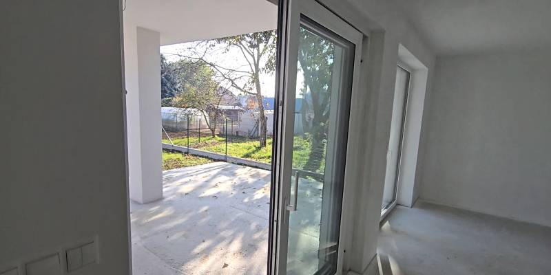 Windows and doors in the family house leading to the terrace, view of the garden.