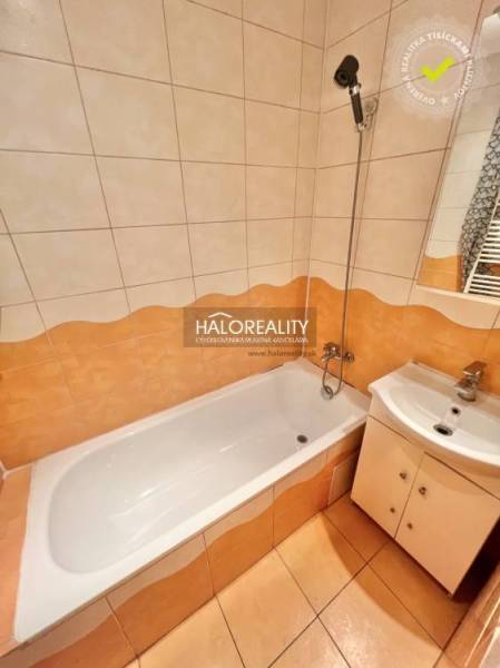 A bathroom in a 4-room apartment with a shower bath and a sink.