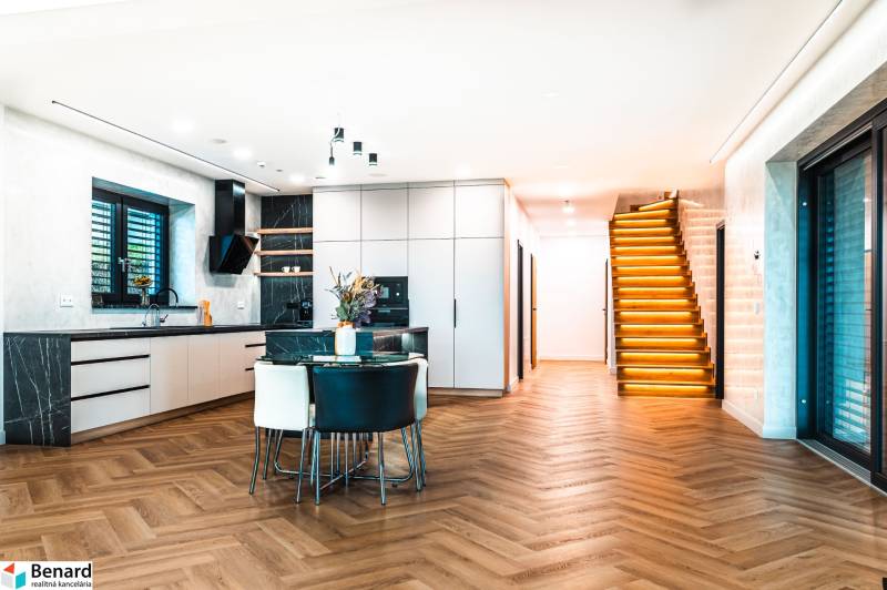 Interior of a family house with a kitchen, staircase, and floor with a wood decor.
