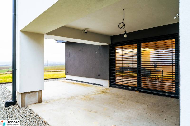 Family house in Stará Ľubovňa with a terrace, glass doors, and a view of the surrounding countryside.