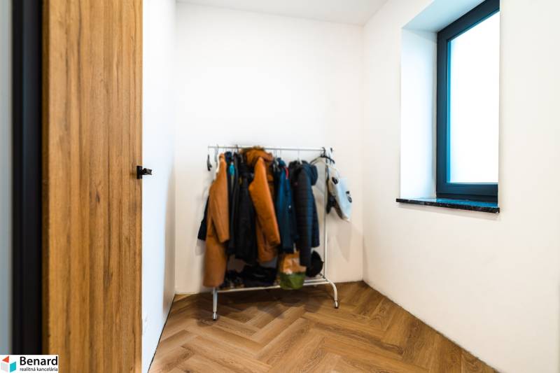 Interior of a family house with a coat rack, floor with wooden decor.