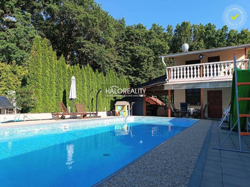 Cottage in Byšta with a pool, terrace, trees, and garden furniture for relaxation.