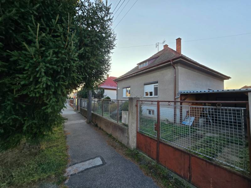 A family house on Slnečná Street in Nové Mesto nad Váhom, with a fence and a sidewalk.