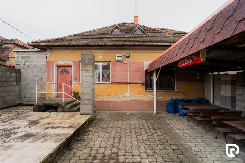A family house on Partizánska Street in Bánovce nad Bebravou with a colorful facade and outdoor seating.