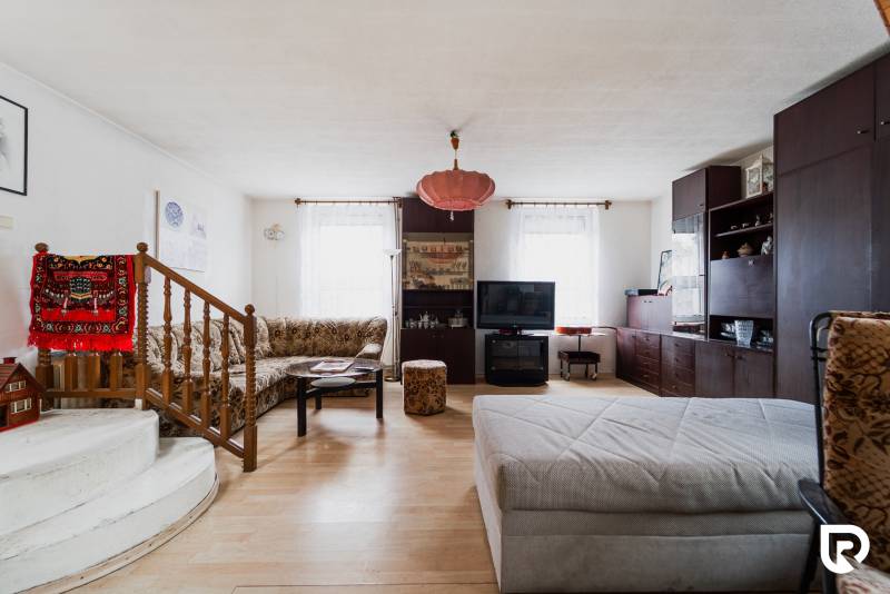 Living room in a family house with a wooden decor floor and comfortable seating.