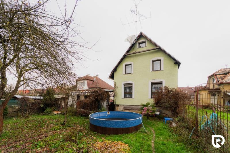 Family house with a swimming pool on Partizánska Street, Bánovce nad Bebravou, in a garden setting.
