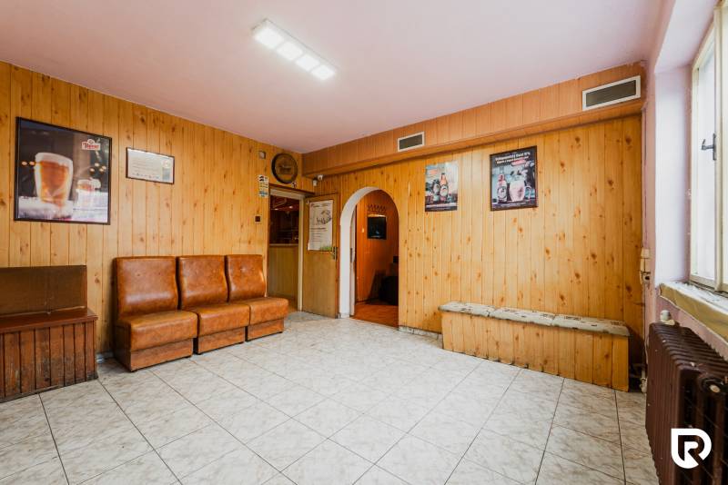 The interior of the house with armchairs, tiles, and paneled walls, tiled floor.