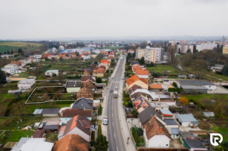 A family house on Partizánska Street in Bánovce nad Bebravou, lined with other houses.