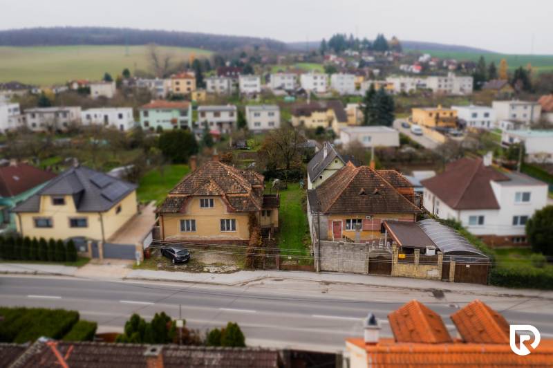 Family houses on Partizánska Street in Bánovce nad Bebravou with the surrounding landscape.