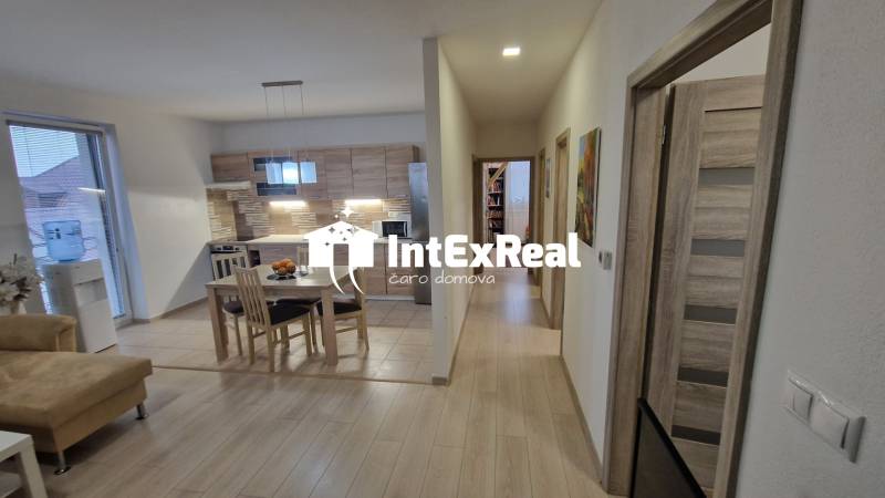 Interior of a 3-room apartment with a kitchen and a wooden decor floor.
