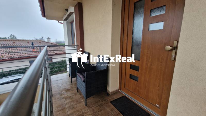 Balcony of a 3-room apartment with seating, view of Vozokany and surrounding rooftops.