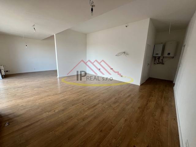 Spacious interior in a 2-room apartment with a wood-decor floor.