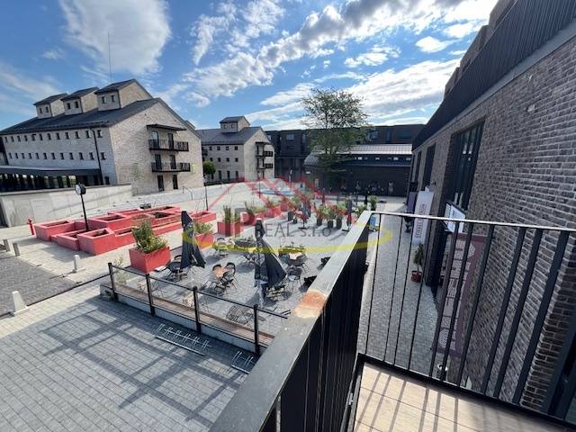 Square exterior at Sýpka in Bratislava - Jarovce with a terrace and brick buildings.