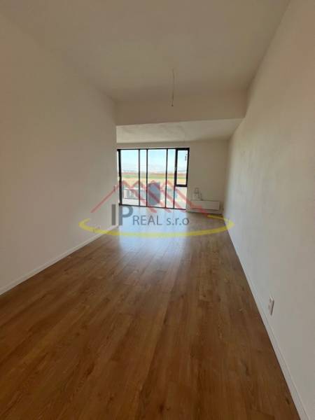 A bright room with a wood-decor floor in a 2-room apartment.